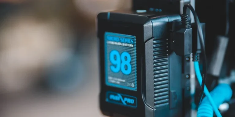 Close-up of a high-capacity portable battery with digital display showing 98 percent charge