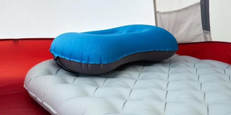Detailed view of inflatable pillow on sleeping pad inside a tent