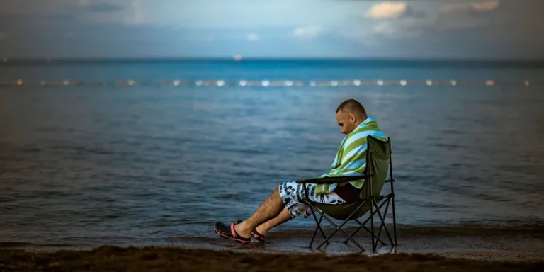 Man quietly seated by Büyükçekmece beach, İstanbul. Calm and serene scene