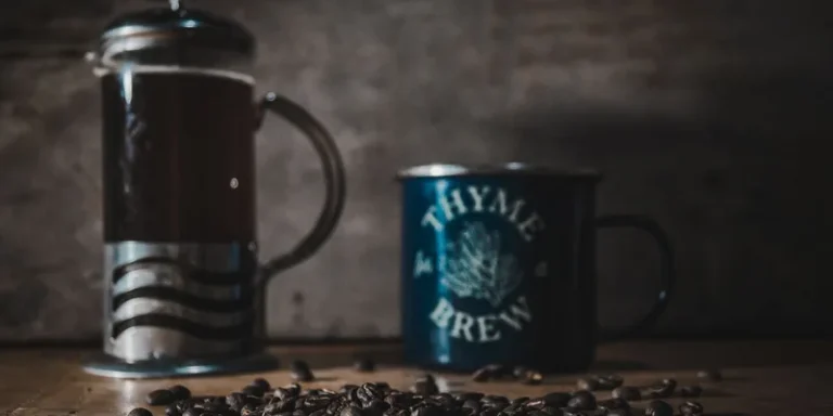 A cozy scene featuring a French press, a mug labeled 'Thyme for Brew', and coffee beans on a wooden table