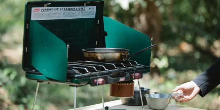 A portable gas stove with pan and equipment outdoors