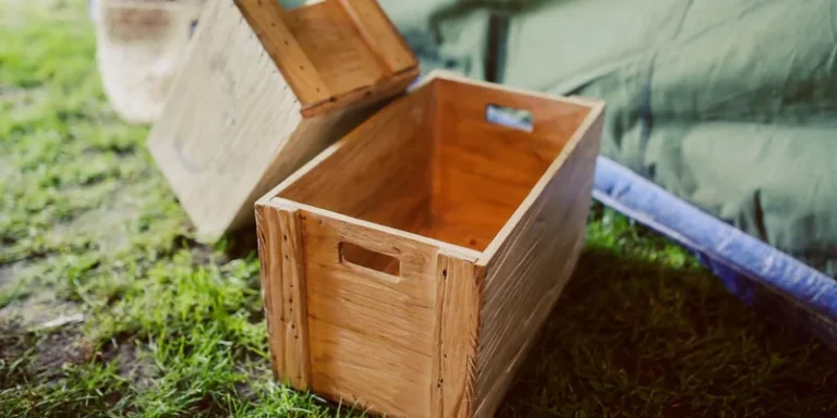 Rustic wooden crates placed on grass in a rural outdoor setting