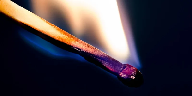 High-resolution close-up of a matchstick igniting
