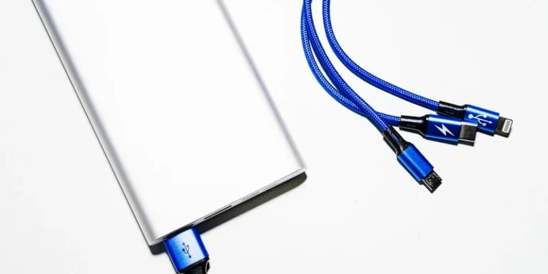Minimalist image of a power bank with blue USB charging cables on a white background