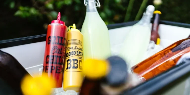Colorful BBQ condiments and refreshing drinks in ice
