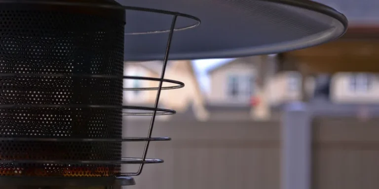 Detailed view of a modern outdoor patio heater with blurred suburban background