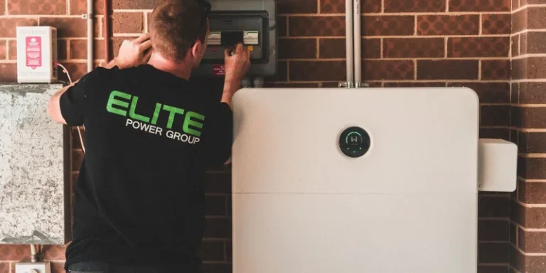 Electrician installing a home energy battery storage unit. Renewable and sustainable energy solution for