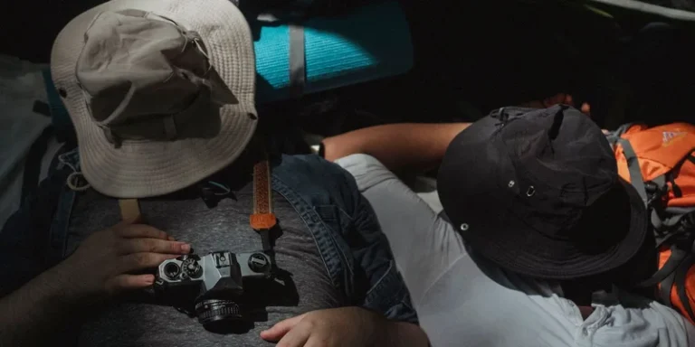 Two hikers napping in a tent